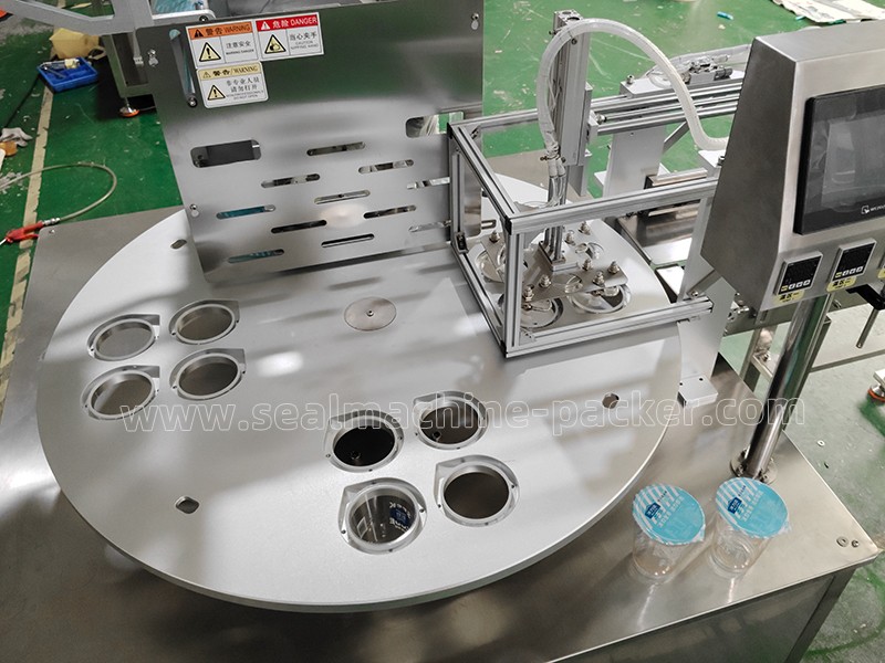 Automatic cup sealing machine seals 4 cups at a time